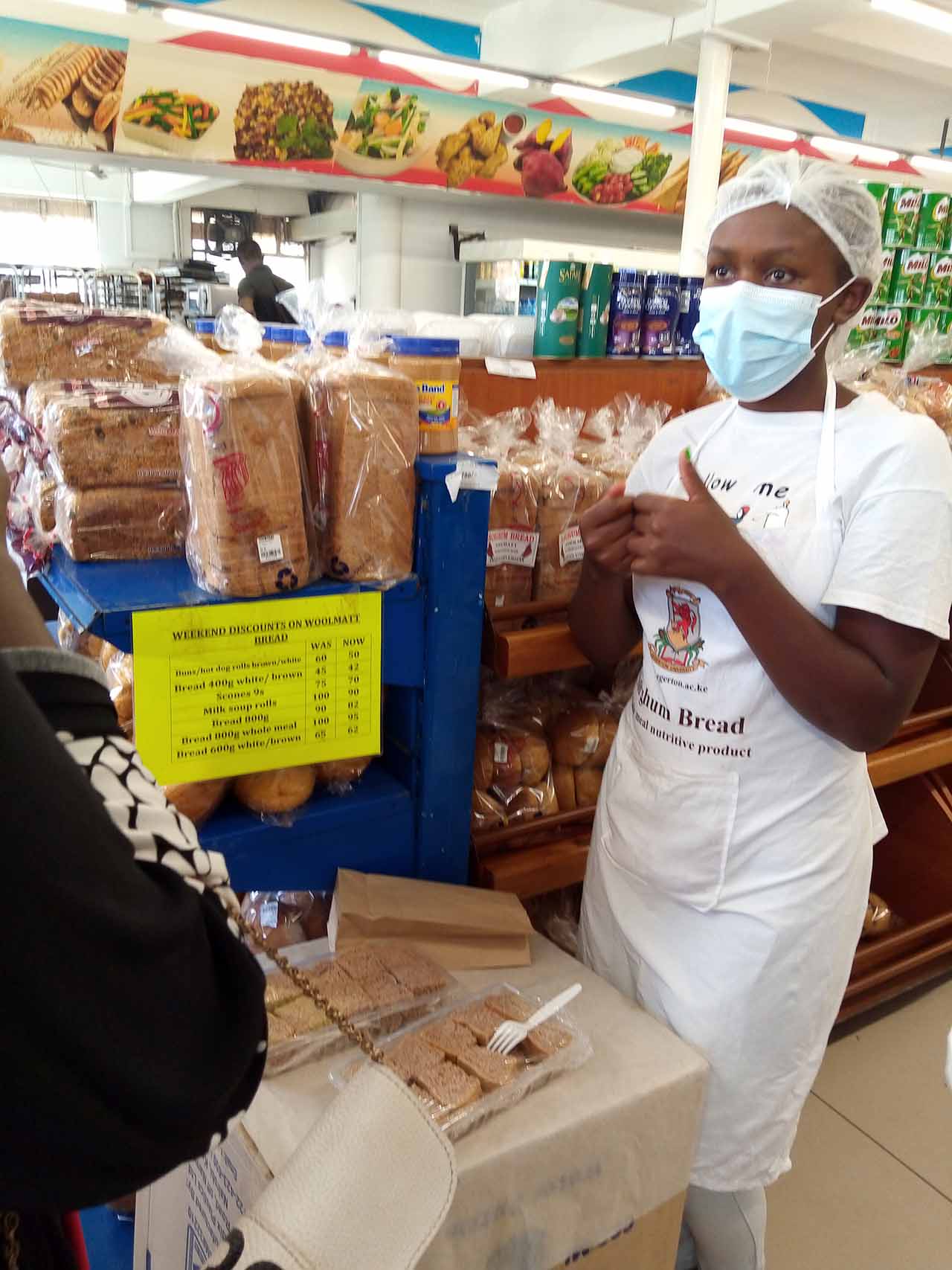 A Food Science student from Egerton University at Woolmatt Supermarket in Nakuru City introduces sorghum bread to customers.