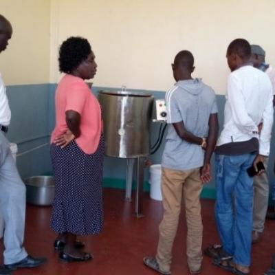 A Group Of Farmers Having An Educational Tour At The Chemeron Honey Processing Room